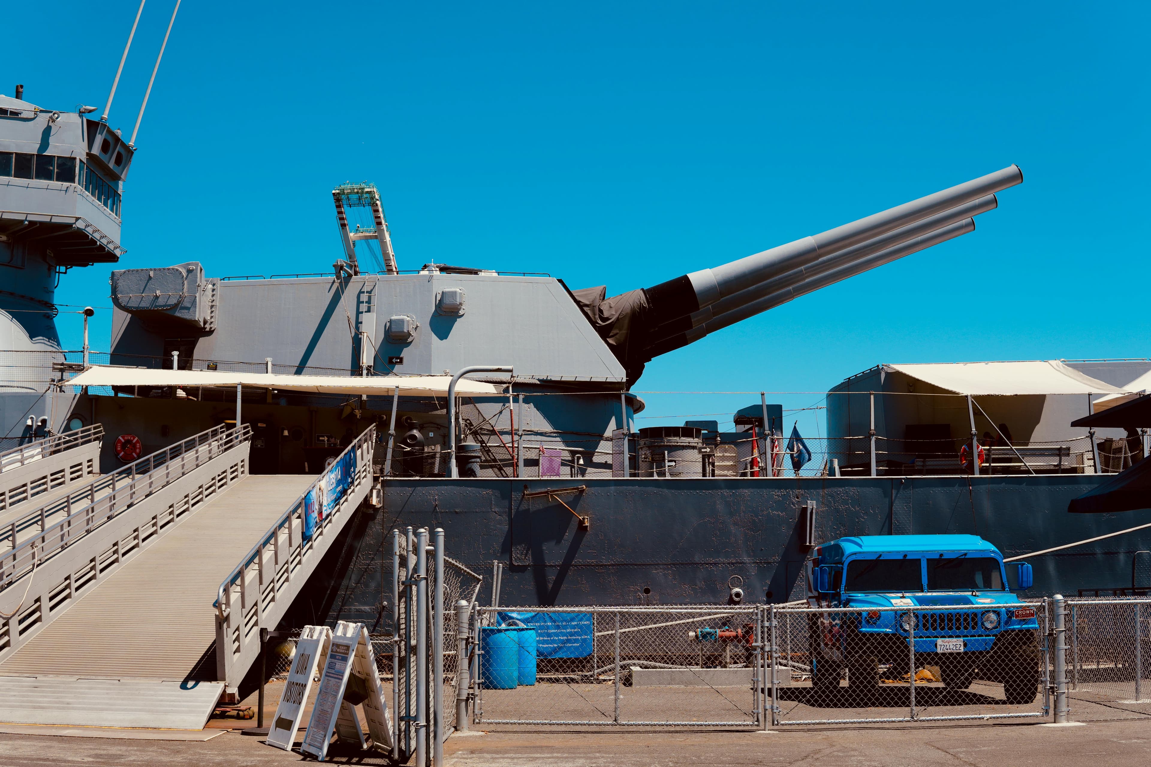 a retouched photo of a battleship gun, three canons abreast and facing right